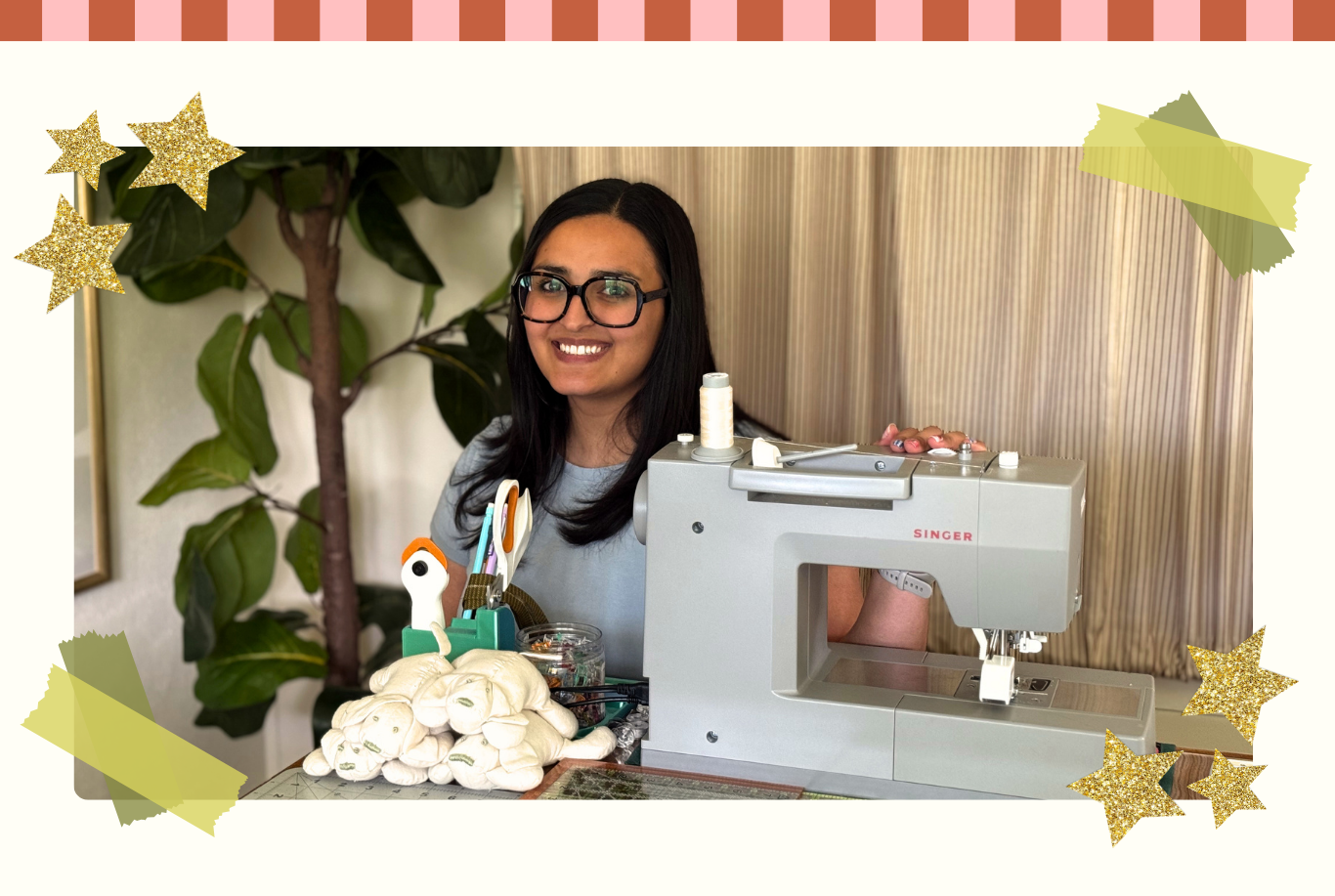 Woman with glasses standing next to a sewing machine with decorative elements around.